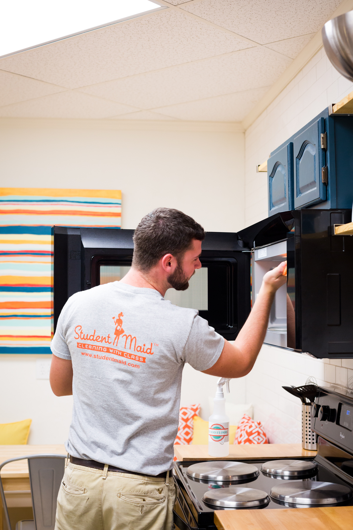 Student Maid Worker cleaning microwave