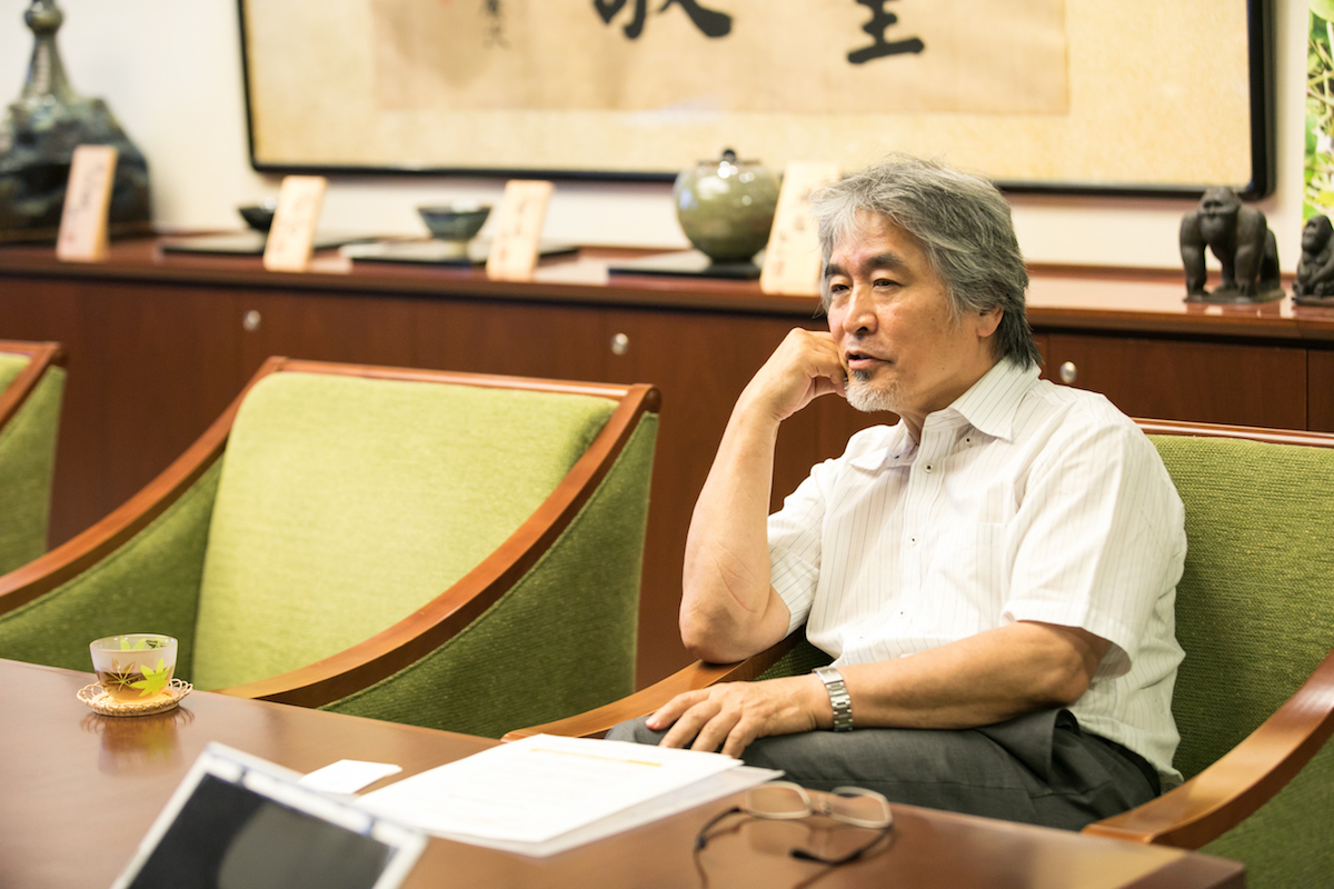 Professor Juinichi leaning in his chair while speaking