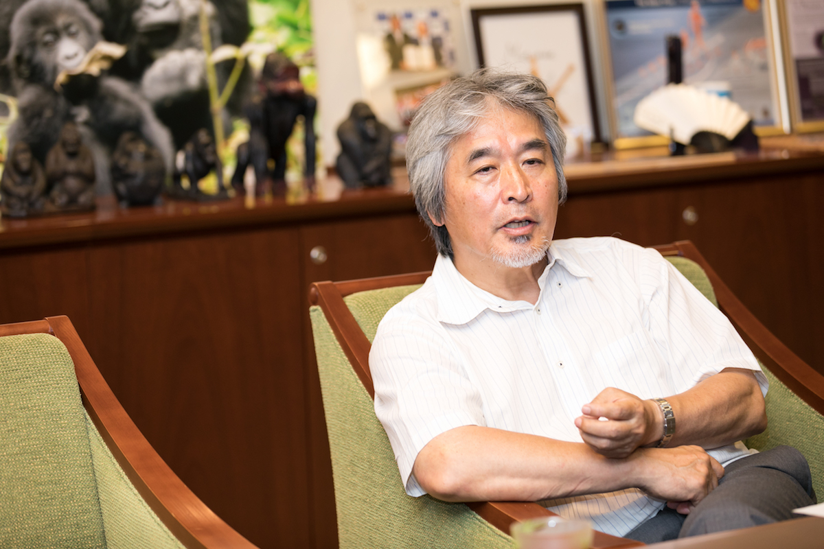 Professor Juinichi sitting in a chair explaining his argument