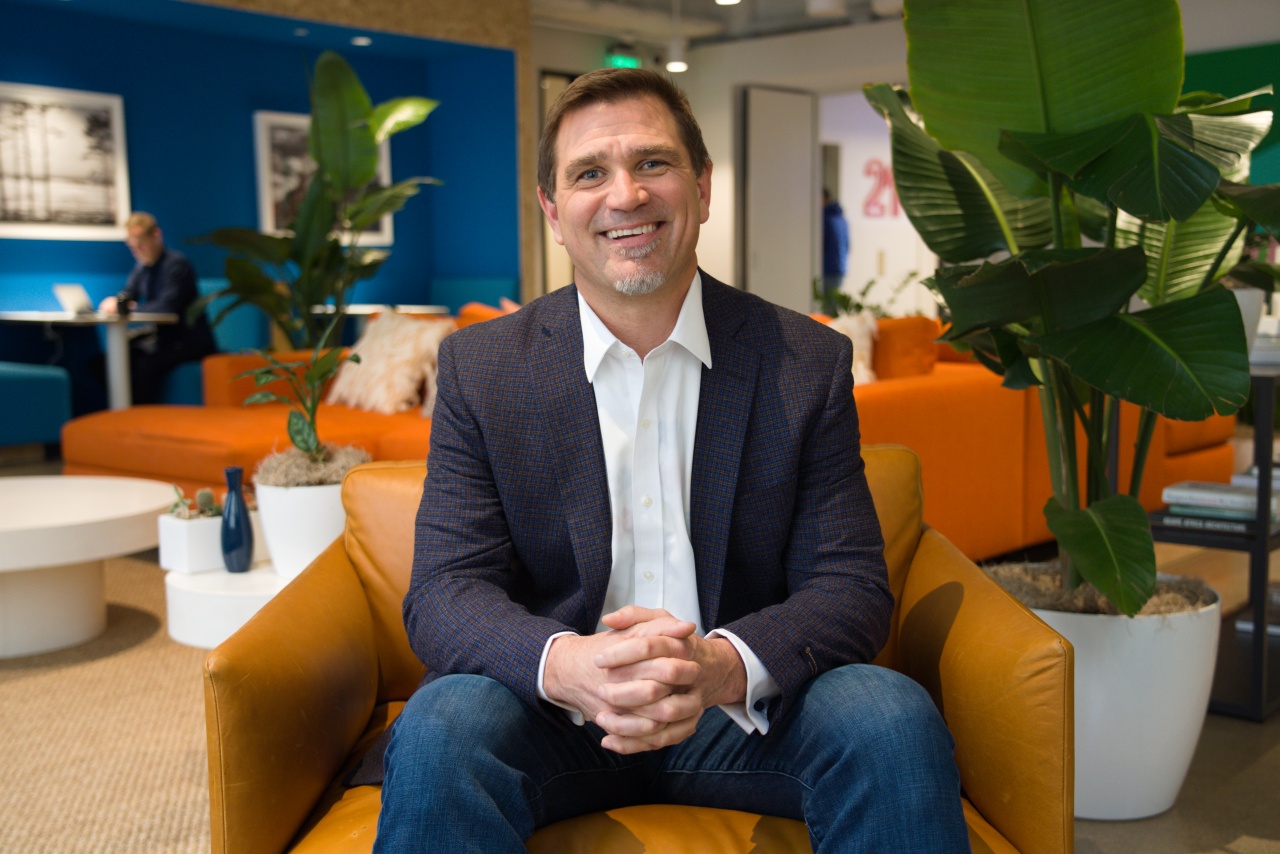 Kintone Corporation CEO Dave Landa, sitting in a chair wearing a shirt and blazer